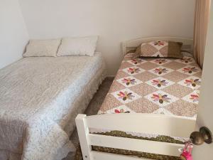 una piccola camera con letto e trapunta di Nuestro rincón a Iquique