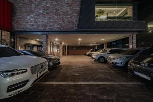 a row of parked cars in a parking lot at Raum Hotel in Seoul