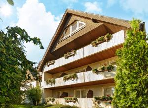 a building with potted plants on the balconies at Hotel-Pension Pöhling in Lippstadt