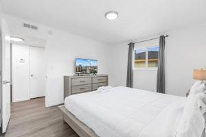 een witte slaapkamer met een groot bed en een raam bij Oceanview Azul 2BR • Bright Top-Floor Condo in Myrtle Beach