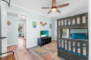 a bedroom with a bunk bed and a ceiling fan at Relax: Private Pool Grill Fire Pit in Myrtle Beach