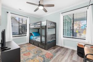 a bedroom with a bunk bed and two windows at Relax: Private Pool Grill Fire Pit in Myrtle Beach +28 photos