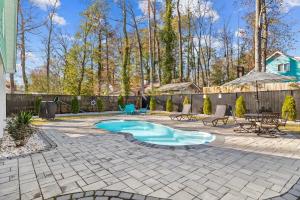 a backyard with a swimming pool and a patio at Relax: Private Pool Grill Fire Pit in Myrtle Beach