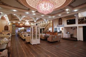 a large room with couches and a chandelier at Hotel Silk Way in Saint Petersburg