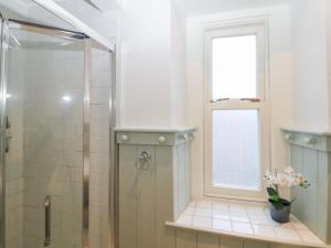 a bathroom with a shower and a window at Dorset Villas in Matlock +12 photos