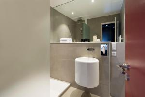 a bathroom with a sink and a mirror at Hôtel Diana Dauphine in Strasbourg +38 photos