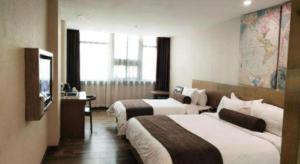 Postel nebo postele na pokoji v ubytování James Joyce Coffetel Baoding Railway Station