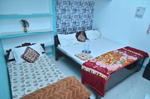 una camera con due letti, un tavolo e un divano di Luv Kush Homestay Ayodhya call now- 7,5,6,5,9,2,4,8,4,4 a Ayodhya