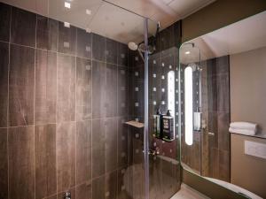 a shower with a glass door in a bathroom at ibis Paris Canal Saint Martin in Paris +56 photos