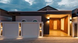 a house with two garage doors in front of it at Rivla A Pool Villa in Ao Nang 