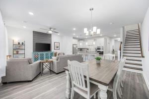 a dining room and living room with a table and chairs at Birdie Bungalow- Games Beach Gear Sleeps 10 in Myrtle Beach