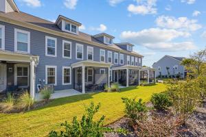 a large house with a yard at Birdie Bungalow- Games Beach Gear Sleeps 10 in Myrtle Beach