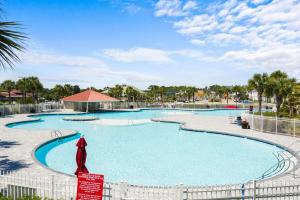 a large swimming pool at a resort at Birdie Bungalow- Games Beach Gear Sleeps 10 in Myrtle Beach