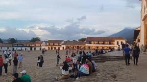 eine Gruppe von Menschen, die auf den Stufen eines Gebäudes sitzen in der Unterkunft CASA NOCHE AZUL alojamiento turístico in Villa de Leyva