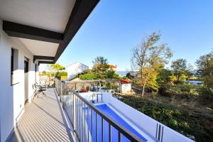 a balcony of a house with a swimming pool at Villa Lily in Privlaka