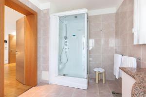 a shower with a glass door in a bathroom at Hotel Campiello in San Giovanni al Natisone