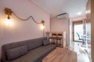 a living room with a couch and a table at Mytilene Central Home 2 in Mytilini +10 photos