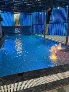 a large pool of water with two people in it at The Inspira Hotel Haridwar in Haridwār