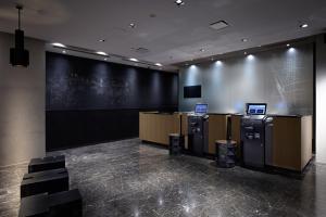 a lobby with a bunch of machines in a room at The Royal Park Canvas Nagoya in Nagoya