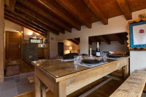 a kitchen with a large wooden island with wine glasses at Résidence Androsace 53 - Happy Rentals in Chamonix-Mont-Blanc +13 photos