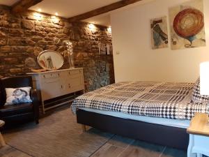 a bedroom with a bed and a mirror at La Ferme de Spa in Spa