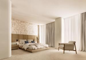 a bedroom with a large bed and a chair at Hotel Kleopatra Inn in Messini +18 photos