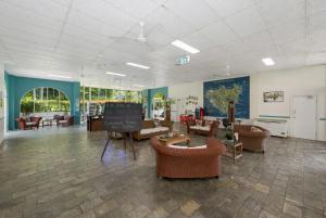a large lobby with couches and chairs and a chalkboard at Unit 133 Amaroo Standard Twin Studio Apartment in Nelly Bay