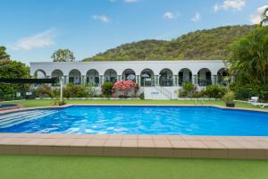 a large swimming pool in front of a building at Unit 133 Amaroo Standard Twin Studio Apartment in Nelly Bay