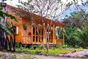 a wooden house in the middle of a garden at DuGiang Homestay in Buon Ma Thuot