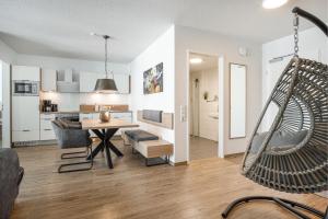 a living room with a hammock and a kitchen at Seeluft Olpenitz in Olpenitz
