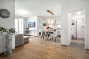 a living room and kitchen with a table and chairs at Ostseebrise Olpenitz in Olpenitz