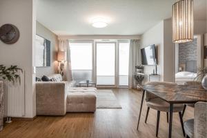 a living room with a couch and a table at Ostseebrise Olpenitz in Olpenitz +17 photos