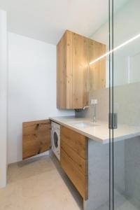 a bathroom with a sink and a washing machine at Apartment Beta in Izola