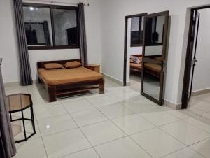 a living room with a bed and a mirror at MiMi24 in Mahajanga +24 photos