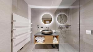 a bathroom with a sink and a mirror at Moonlight Apartments in Söll