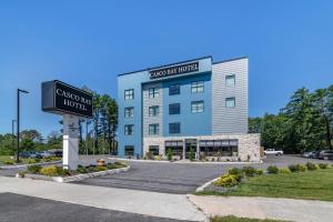 a building with a street sign in front of it at Casco Bay Hotel Portland Airport - Maine Mall, an Ascend Collection Hotel in South Portland