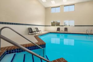 a large pool with blue tiles in a building at Baymont by Wyndham Blackwell I-35 in Blackwell