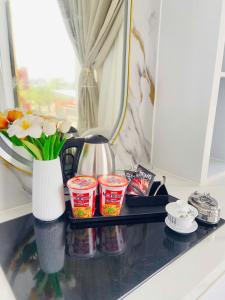 a counter with a tray with cups and flowers on it at Khách sạn Nữ Vương in Xom Ông Linh