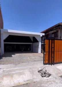 a large building with a large garage with a large door at Utama Guest House Kuta Alam in Banda Aceh