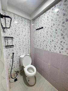 a bathroom with a toilet in a room at Utama Guest House Kuta Alam in Banda Aceh
