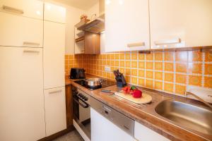 a kitchen with white cabinets and a sink at Schnuckeliges Appartement in Sankt Andreasberg