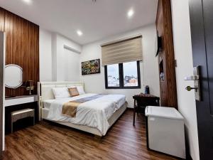 a bedroom with a large bed and a window at Khách sạn Thy Thảo 3 in Ho Chi Minh City