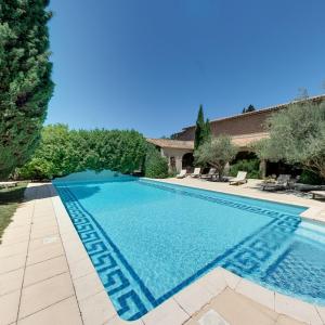 a swimming pool in the backyard of a house at Hôtel Château de Cavanac in Carcassonne