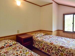 En eller flere senge i et værelse på Pension Noel