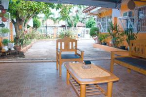 a room with a table and a chair and a bench at Namasté Olango Guest House in Olango Island