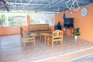 a room with chairs and a table and a tv at Namasté Olango Guest House in Olango Island +9 photos