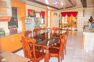 a kitchen with a table and chairs and a refrigerator at Namasté Olango Guest House in Olango Island