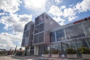a building with glass windows on the side of it at Hotel I Crespi in Grosseto