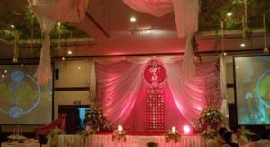 a stage with a pink curtain in a room at Royal Diamond Hotel in Phetchaburi