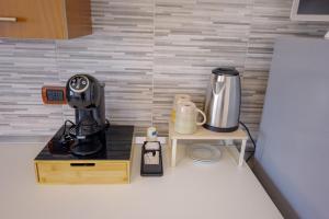 a kitchen with a counter with a coffee maker on a table at Tree home in Salerno Airport - Aeroporto di Salerno